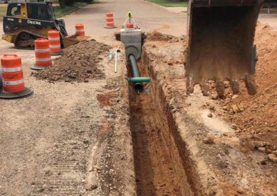Utility trench with a pipe laying down.